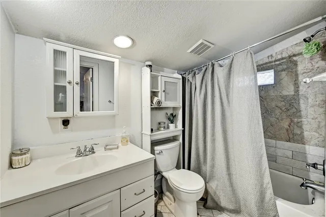 a bathroom with a sink toilet a mirror and shower