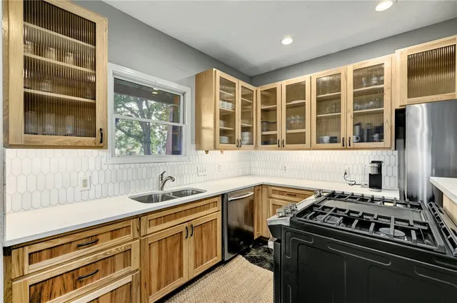 a kitchen that has a sink and a stove