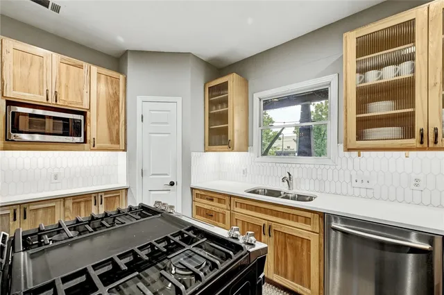 a kitchen with a stove and a sink