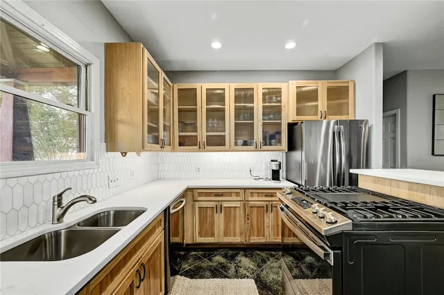 a kitchen that has a sink and a stove