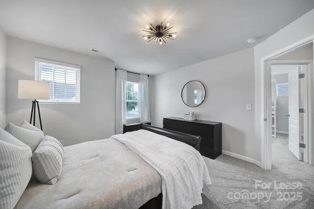 a bedroom with a bed and a chandelier