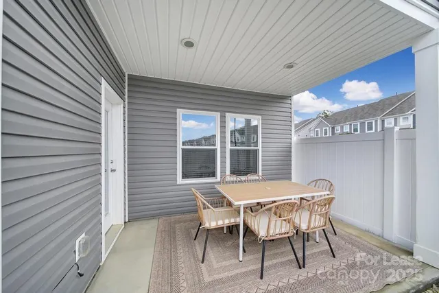 a table and chairs in front of a house