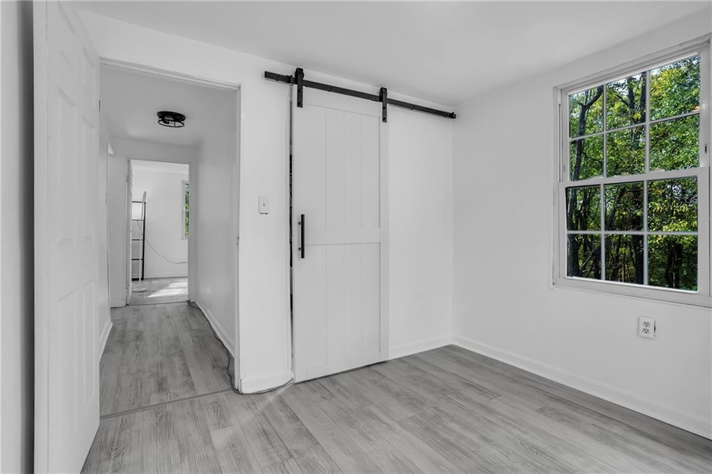 215 Harshaville Road Clinton, PA 15026 - Photo 16 of 30 a view of an empty room with wooden floor and a window