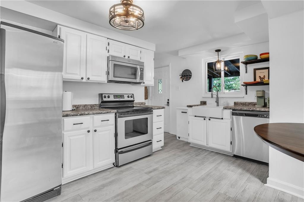 215 Harshaville Road Clinton, PA 15026 - Photo 3 of 30 a kitchen with stainless steel appliances white cabinets and a sink