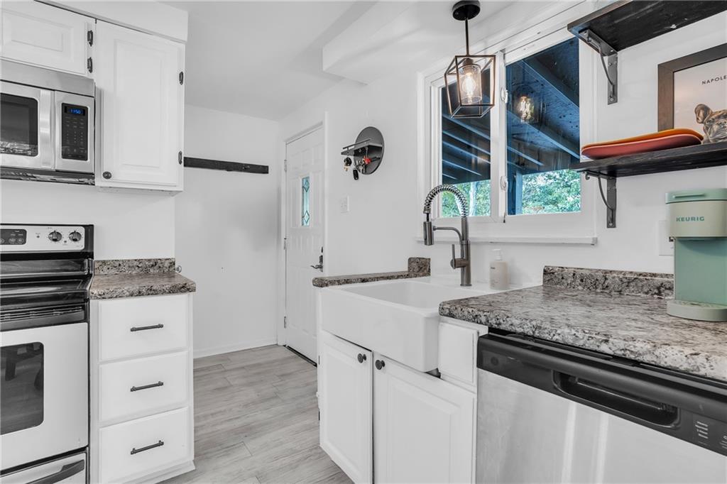215 Harshaville Road Clinton, PA 15026 - Photo 4 of 30 a kitchen with stainless steel appliances granite countertop a sink stove and refrigerator