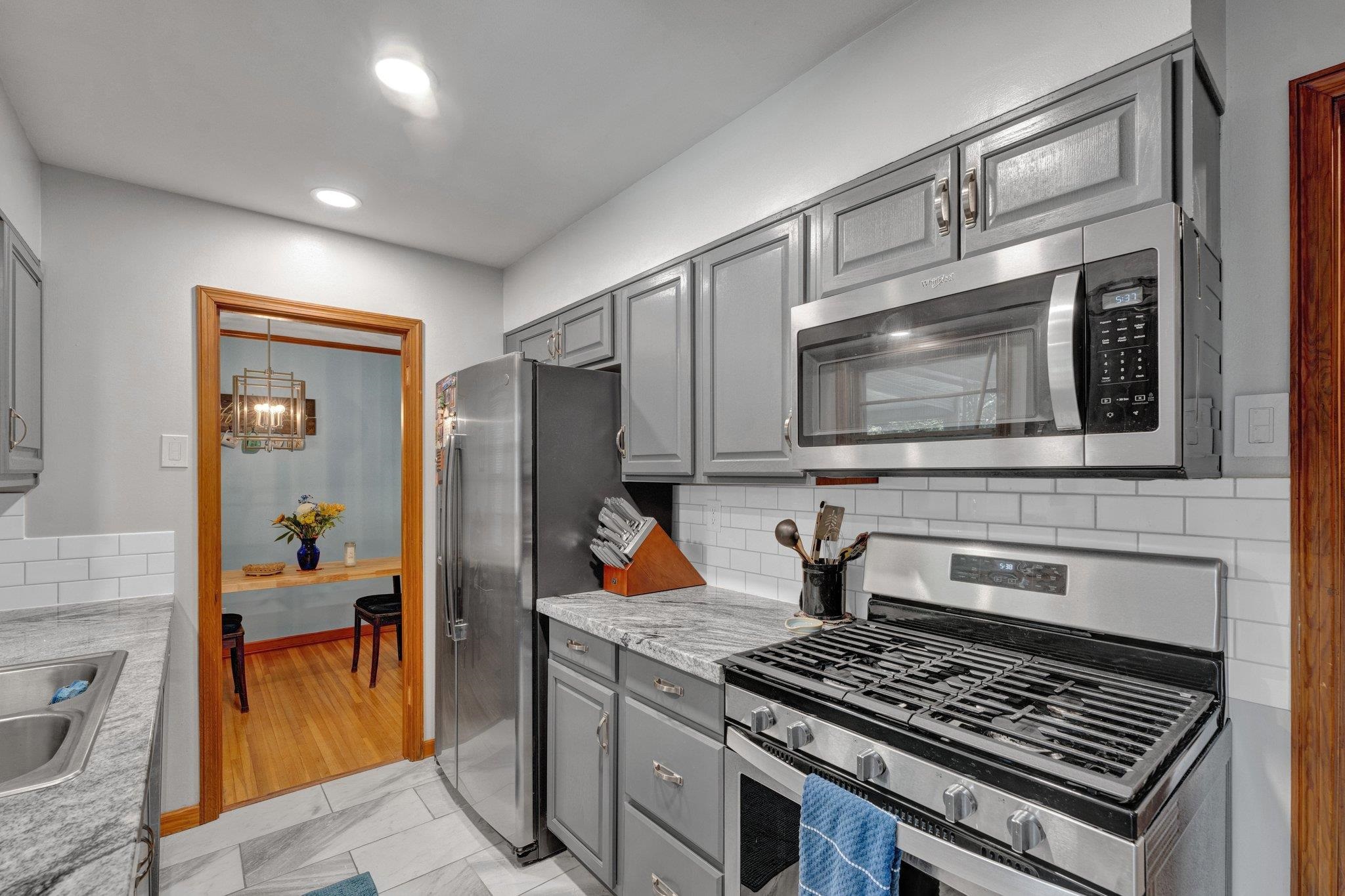 1585 Dearing Road Memphis, TN 38117 - Photo 17 of 34 a kitchen with stainless steel appliances granite countertop a stove and a microwave