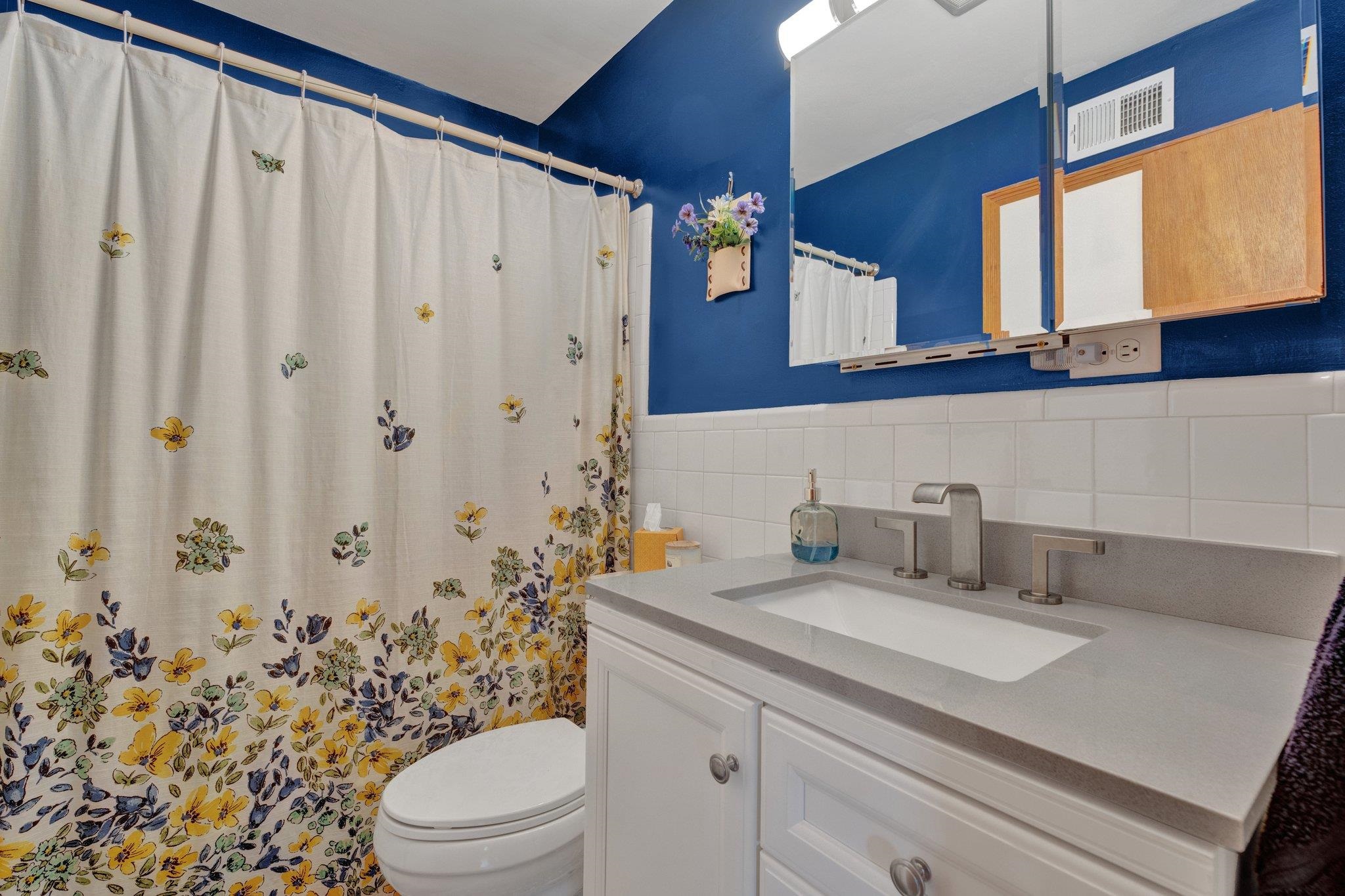 1585 Dearing Road Memphis, TN 38117 - Photo 8 of 34 a bathroom with a granite countertop sink a toilet and a mirror