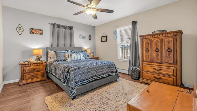 a bedroom with a bed and wooden floor