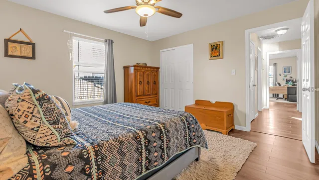 a bedroom with a bed and wooden floor
