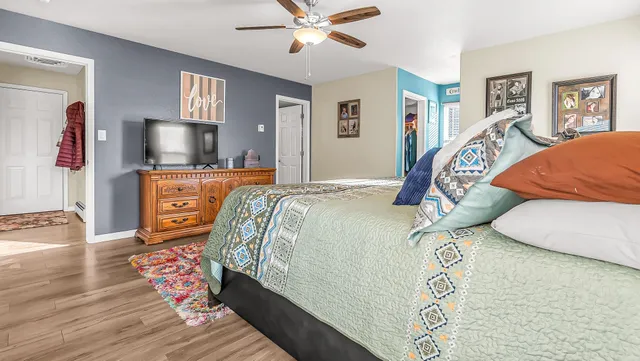 a bedroom with a bed and wooden floor