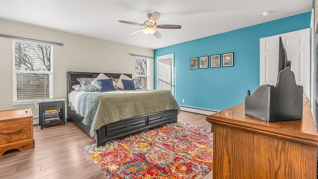 a bedroom with bed and wooden floor
