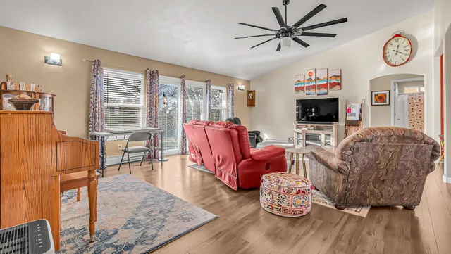 a living room with furniture a fireplace and a flat screen tv