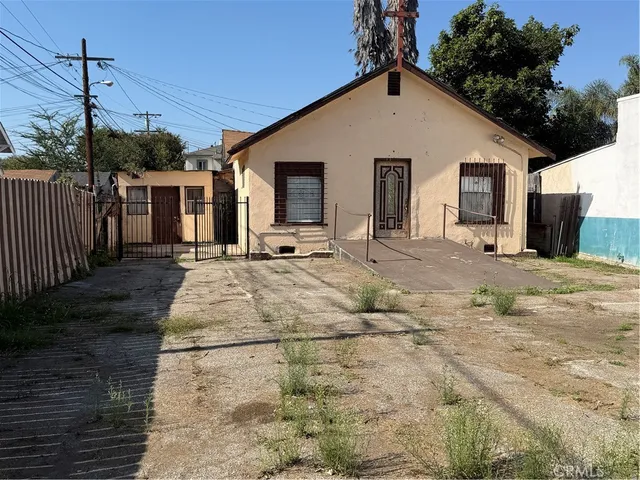 a view of a house with wooden fence