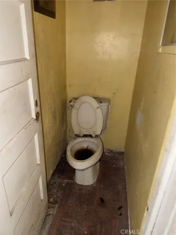 a toilet sitting in a bathroom next to a sink