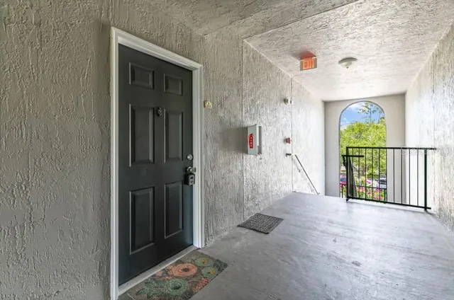 a view of entryway with a floor to ceiling window and carpet
