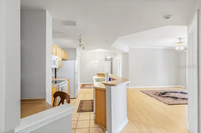 a kitchen with a appliances a sink and a refrigerator