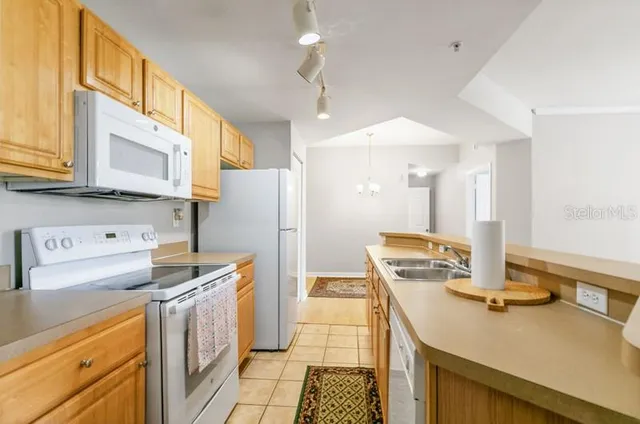 a bedroom with a bed windows and a rug
