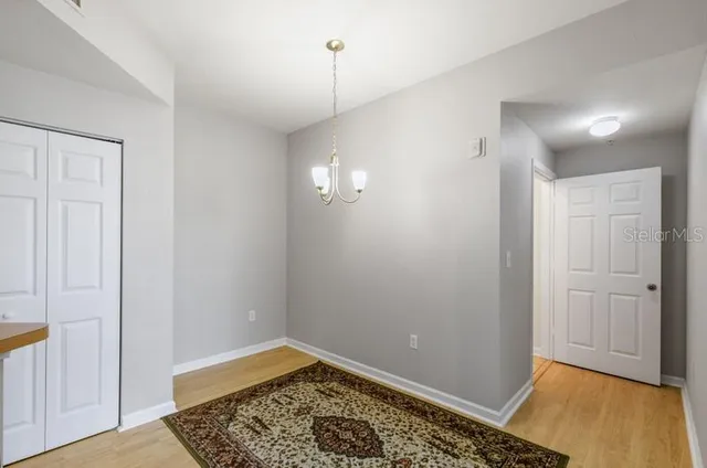 a view of kitchen and hall with wooden floor