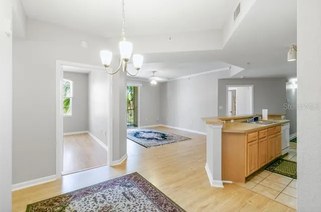 a view of a livingroom with wooden floor and a rug