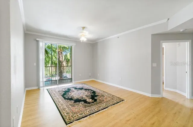a view of a livingroom with wooden floor and a rug