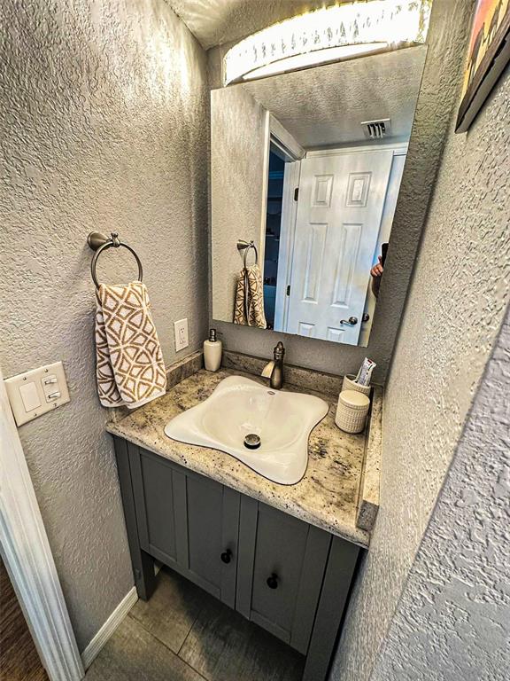 8911 Blind Pass Road, Unit 220 St. Pete Beach, FL 33706 - Photo 49 of 67 a bathroom with a sink and a mirror