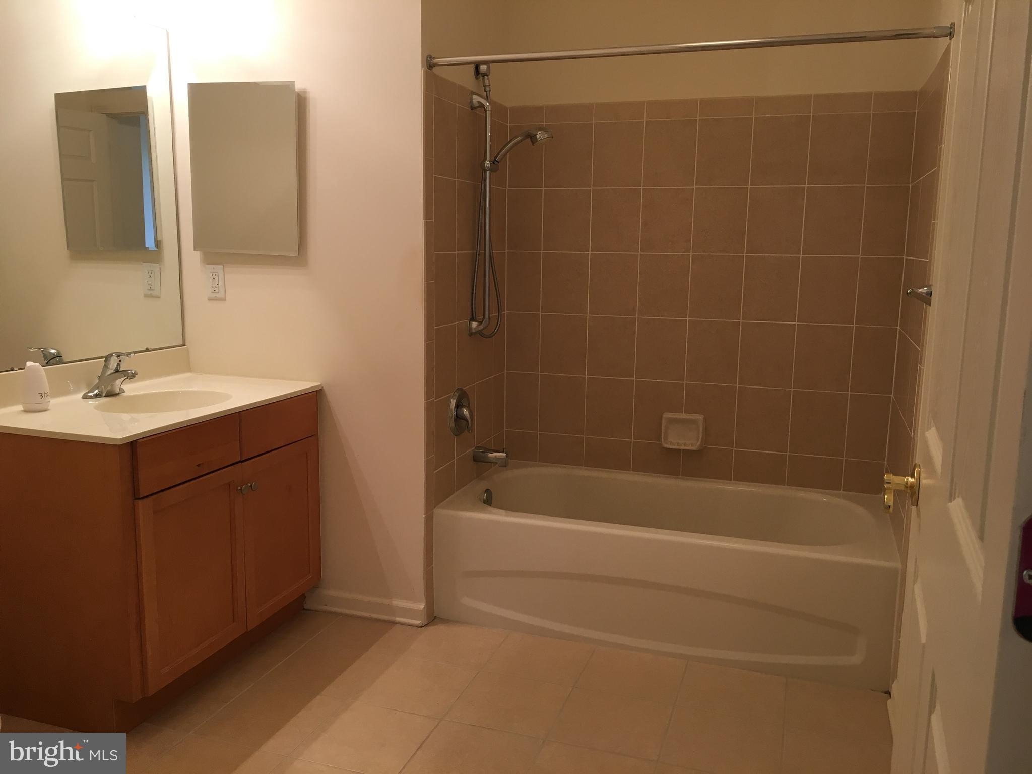 245 Masterson Court Ewing, NJ 08618 - Photo 13 of 21 a bathroom with a sink a toilet and shower