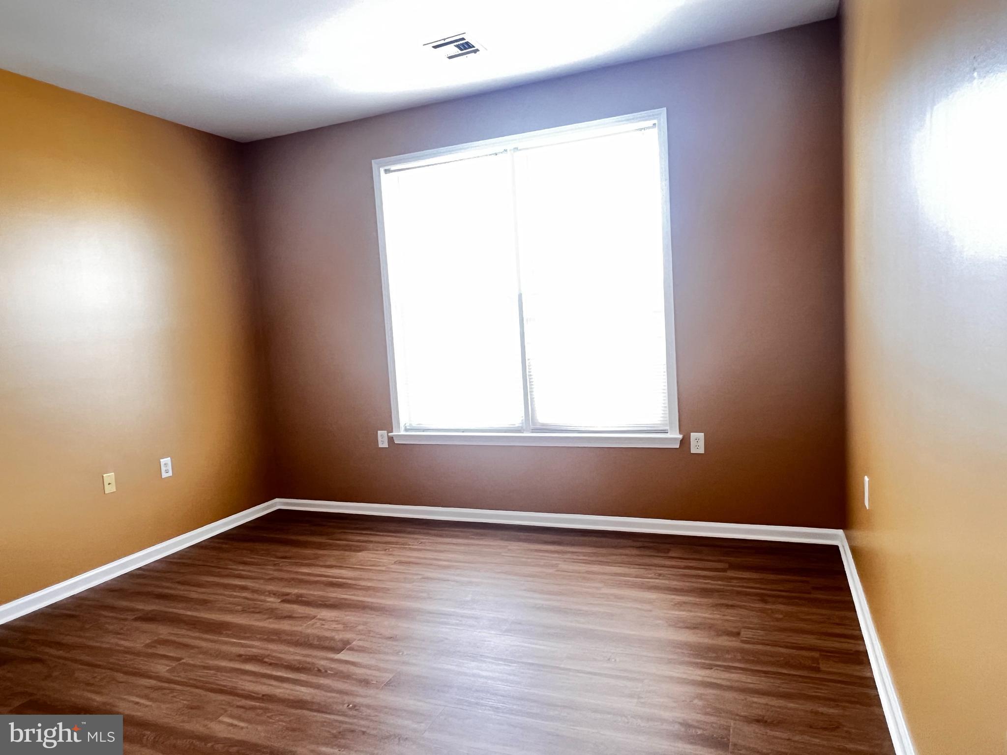 245 Masterson Court Ewing, NJ 08618 - Photo 17 of 25 an empty room with wooden floor and windows