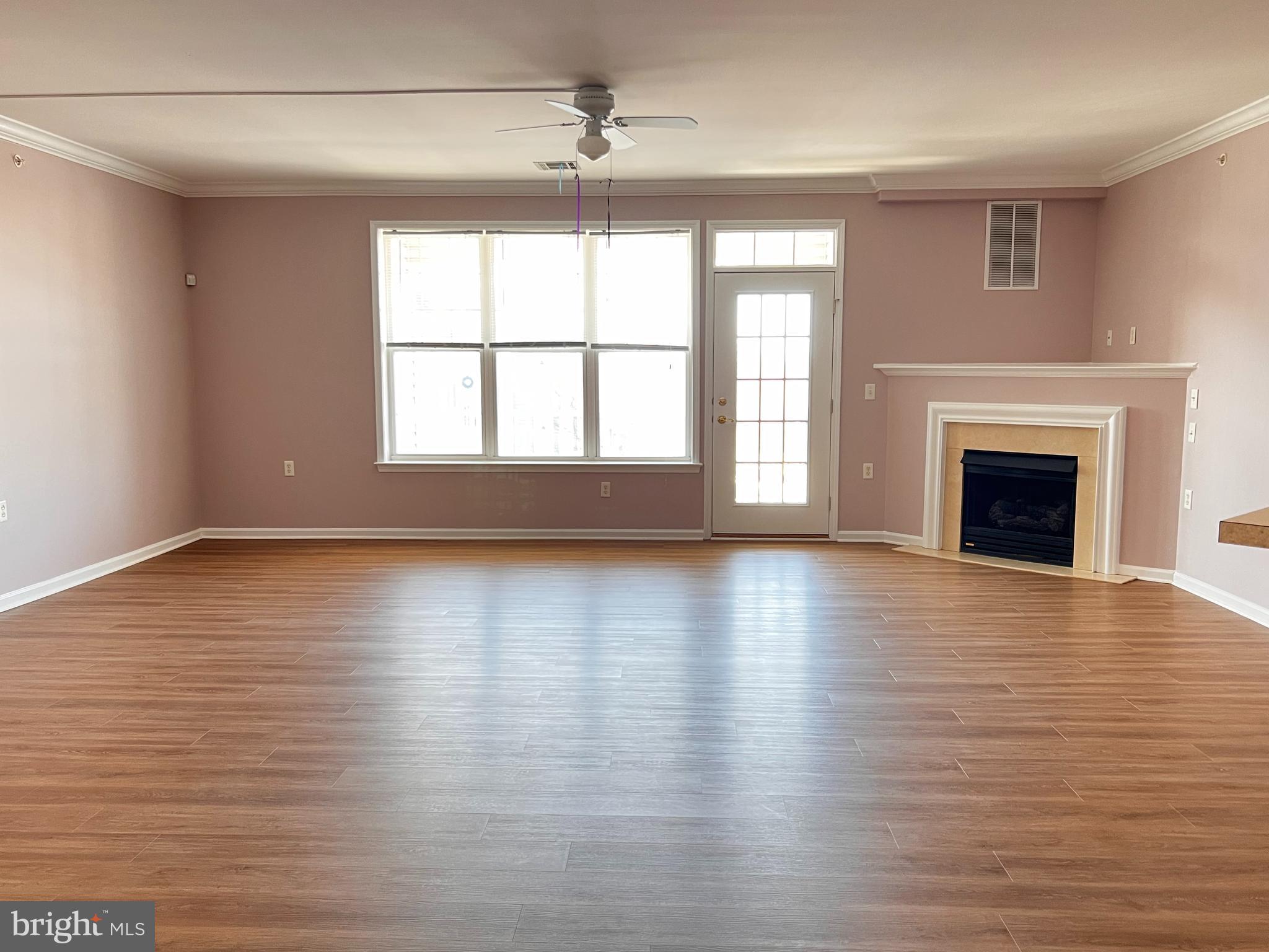 245 Masterson Court Ewing, NJ 08618 - Photo 6 of 25 an empty room with wooden floor fireplace and windows