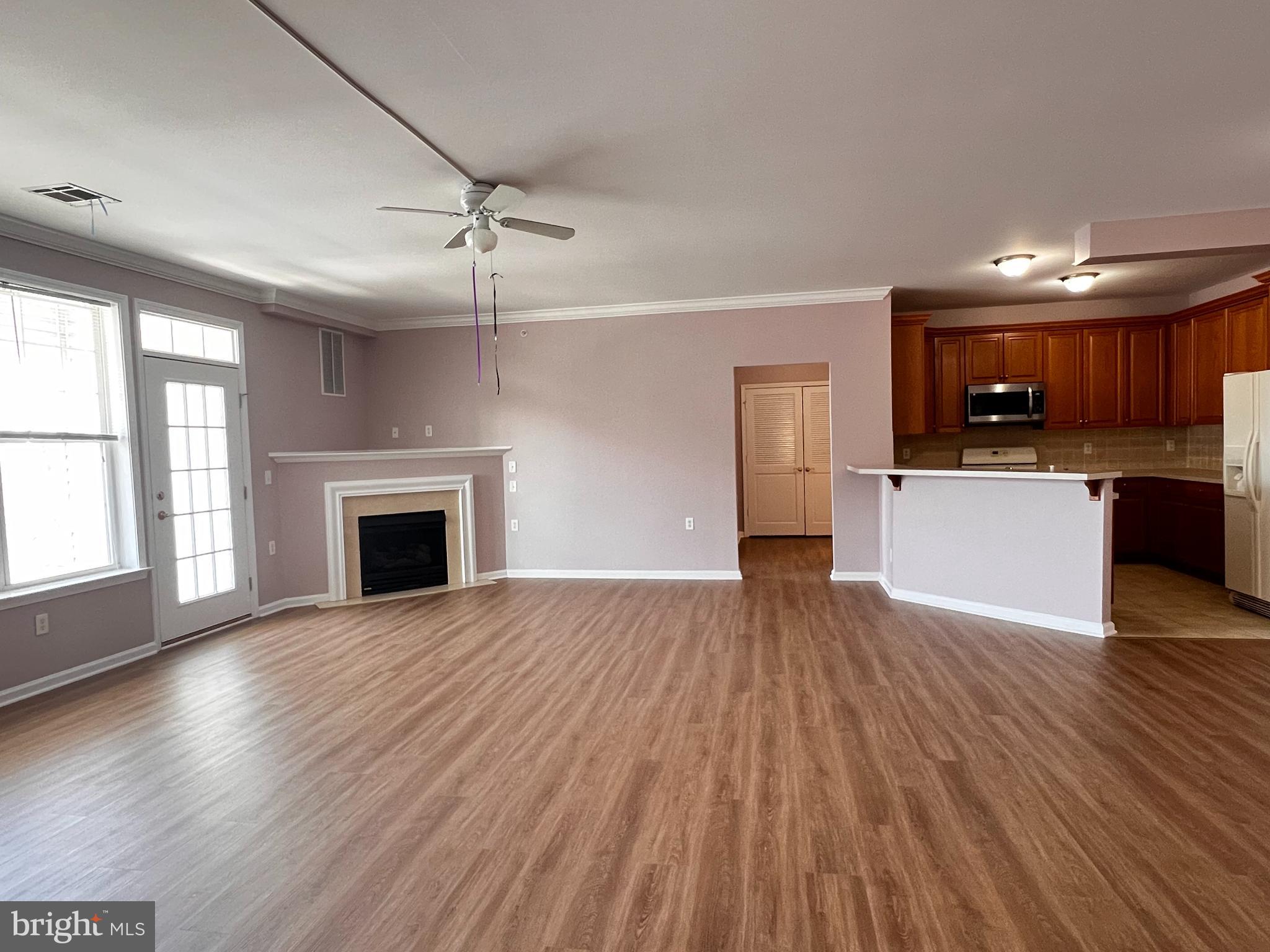 245 Masterson Court Ewing, NJ 08618 - Photo 7 of 25 a view of kitchen with microwave a stove and wooden floor