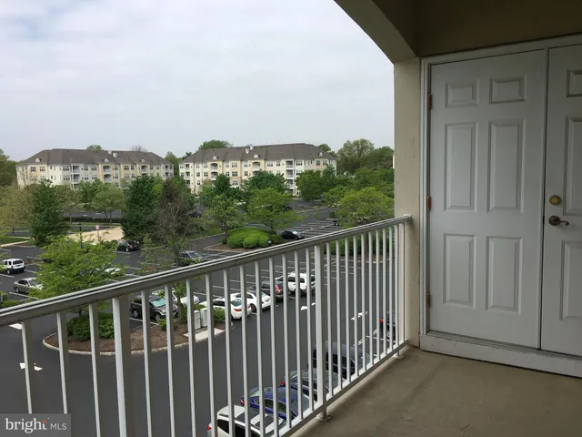 a balcony with wooden floor and city view