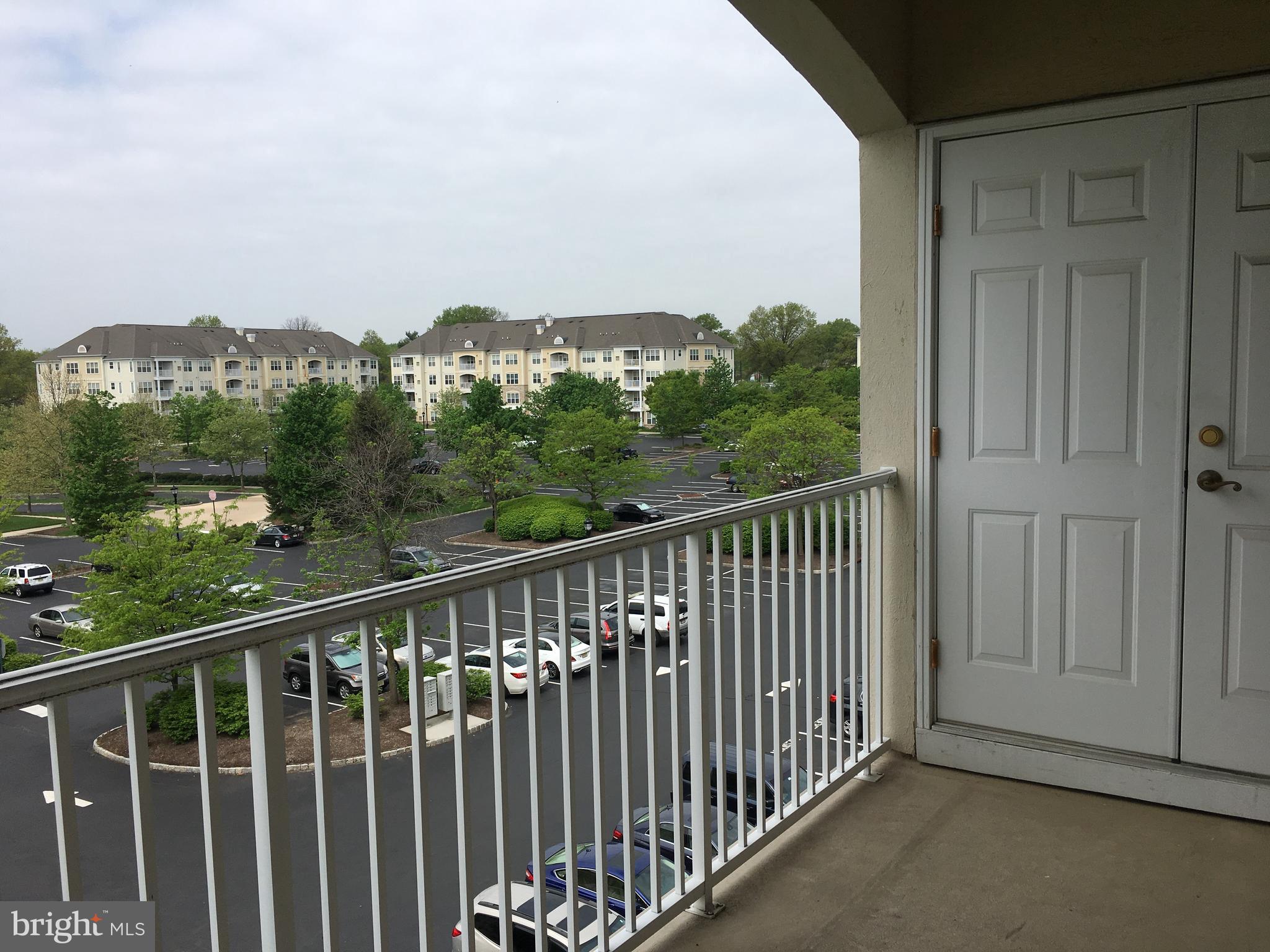 245 Masterson Court Ewing, NJ 08618 - Photo 7 of 21 a balcony with wooden floor and city view
