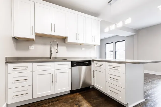 a kitchen with stainless steel appliances cabinets and a window