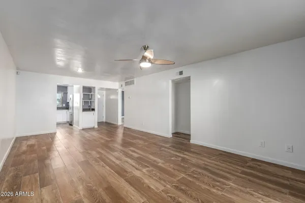 wooden floor in an empty room with a window