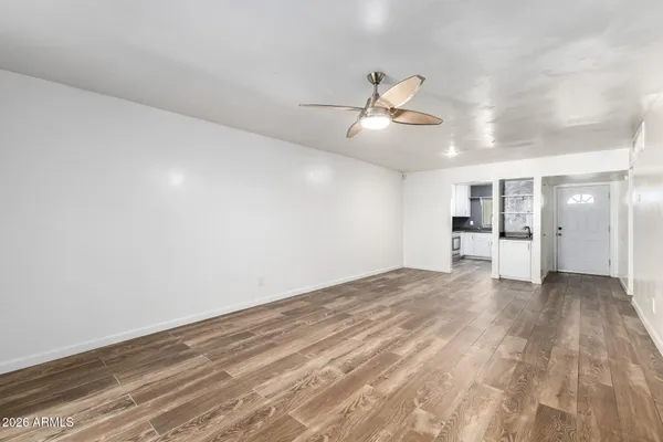 a kitchen with stainless steel appliances granite countertop a sink and cabinets with wooden floor