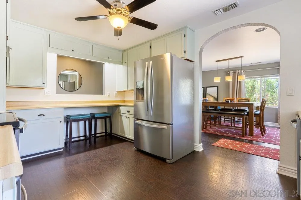 714 Steffy Road Ramona, CA 92065 - Photo 11 of 25 a kitchen with stainless steel appliances granite countertop a refrigerator a stove and a sink with wooden floor