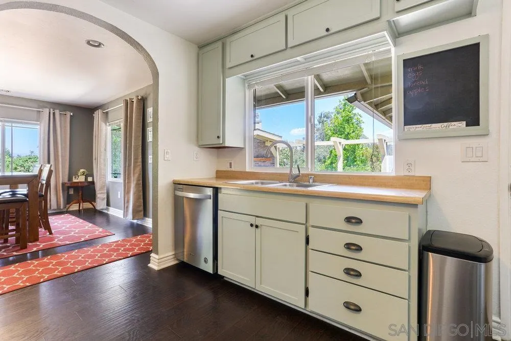 714 Steffy Road Ramona, CA 92065 - Photo 12 of 25 a kitchen with a wooden floor and a large window