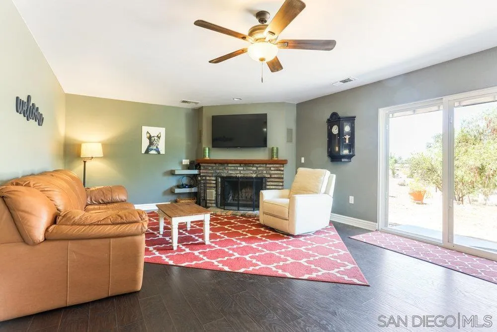 714 Steffy Road Ramona, CA 92065 - Photo 13 of 25 a living room with furniture a fireplace and a flat screen tv