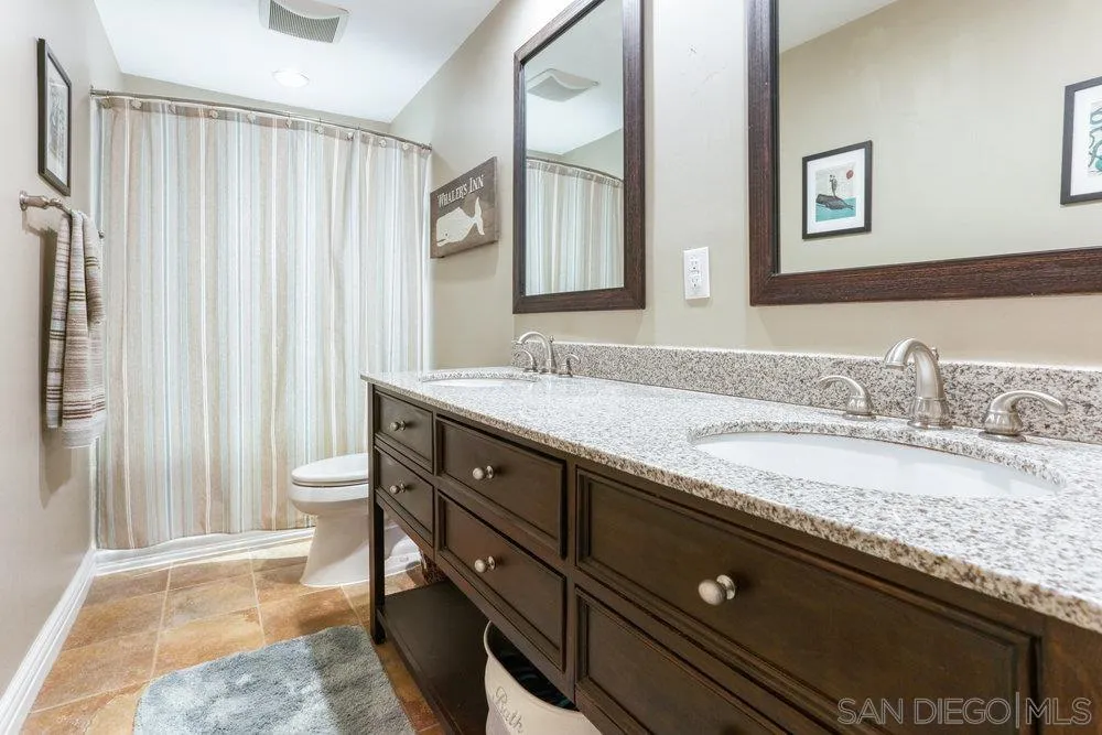 714 Steffy Road Ramona, CA 92065 - Photo 16 of 25 a bathroom with a granite countertop sink and a mirror