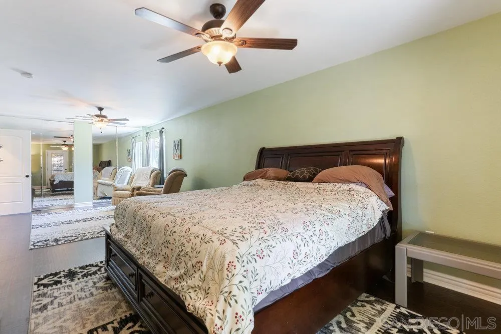 714 Steffy Road Ramona, CA 92065 - Photo 17 of 25 a bed room with a bed and a chandelier