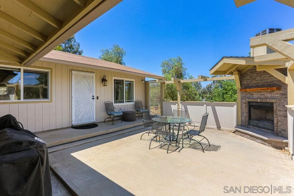 714 Steffy Road Ramona, CA 92065 - Photo 5 of 25 a view of a patio with a dining table and chairs with a fire pit