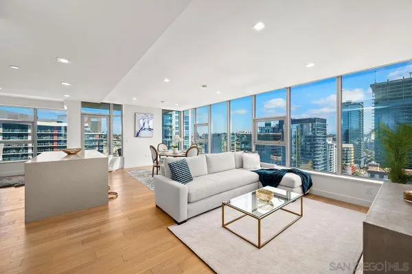 a living room with furniture wooden floor and a large window