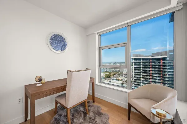 a large kitchen with stainless steel appliances lots of white furniture a sink and a stove