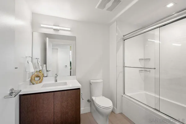 a bedroom with a large bed and a flat tv screen on a dresser