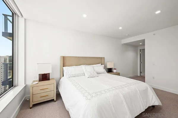 a bedroom with a large bed and a large window