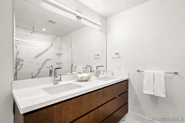 a large bed sitting in a bedroom next to a window and closet