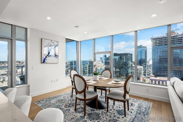 a dining room with furniture and wooden floor