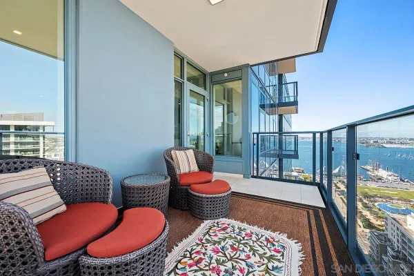 a living room with furniture and a floor to ceiling window