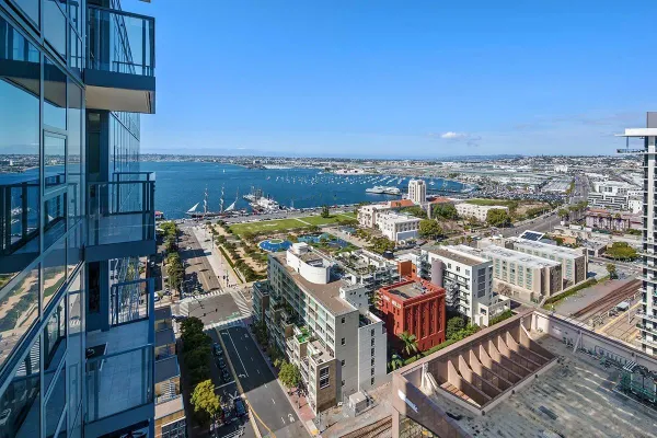 a view of the patio with dining table and chairs under an umbrella