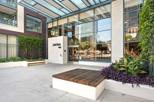 a living room with furniture and large windows