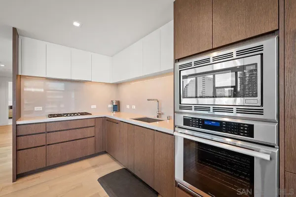 a kitchen with stainless steel appliances a stove a sink and a refrigerator